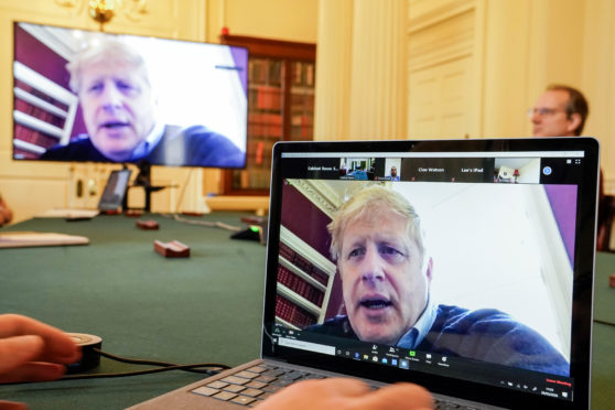 Boris Johnson chairs a Covid-19 meeting via video call