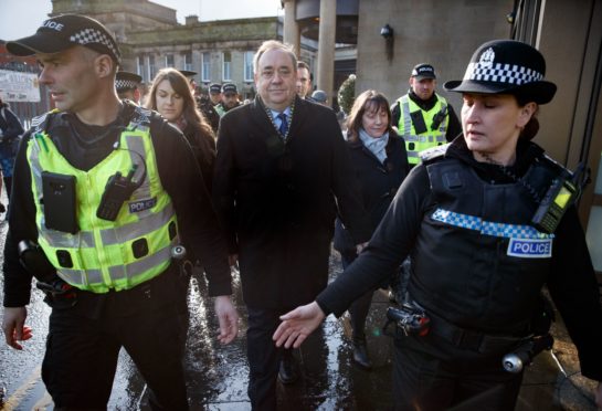 Former First Minister Alex Salmond arrives at the High Court in Edinburgh with a police escort as the trial over attempted rape and sexual assault charges begins. He denies all the charges