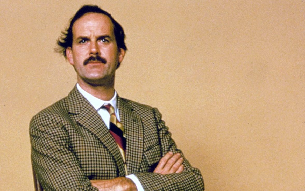 John Cleese as bungling hotelier Basil Fawlty in Fawlty Towers, as Which? reveals why holidaymakers should contact hotels directly