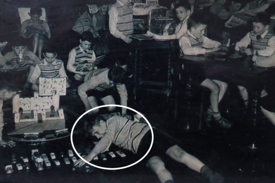Eddie McColl’s youngest brother Francis, circled, playing with                        other children at Smyllum Park orphanage where he was kept apart from siblings before his death in 1961