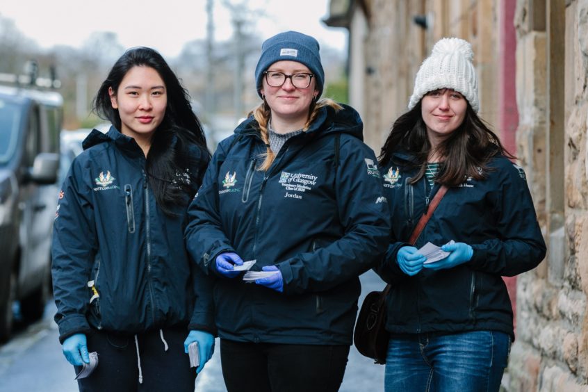 Rainbow Leung, Jordan Dosker and Elizabeth Hoose delivering leaflets