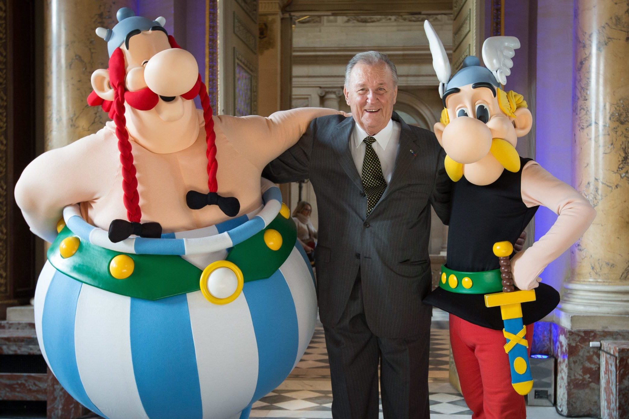 Illustrator Albert Uderzo with cosplayers as his much-loved characters Obelix and Asterix in Paris in 2015