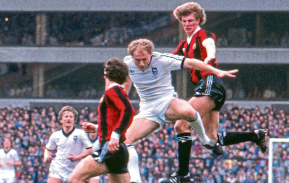 Alan Brazil challenges Manchester City’s Tommy Caton in 1981