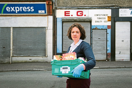 Charity manager Laura Reilly at Crawfords Burn Community Centre in Greenock with food box for vulnerable