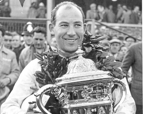 Stirling Moss with the Aintree 200 trophy in 1954