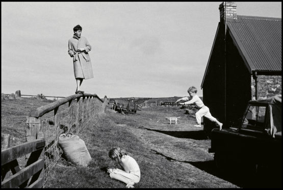 Linda McCartney’s photo shows Paul on fence, Stella at front as James jumps from the Land Rover at their Mull of Kintyre farmhouse in 1982