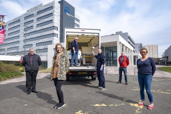 GCU staff loading up a van with equipment  for NHS Louisa Jordan