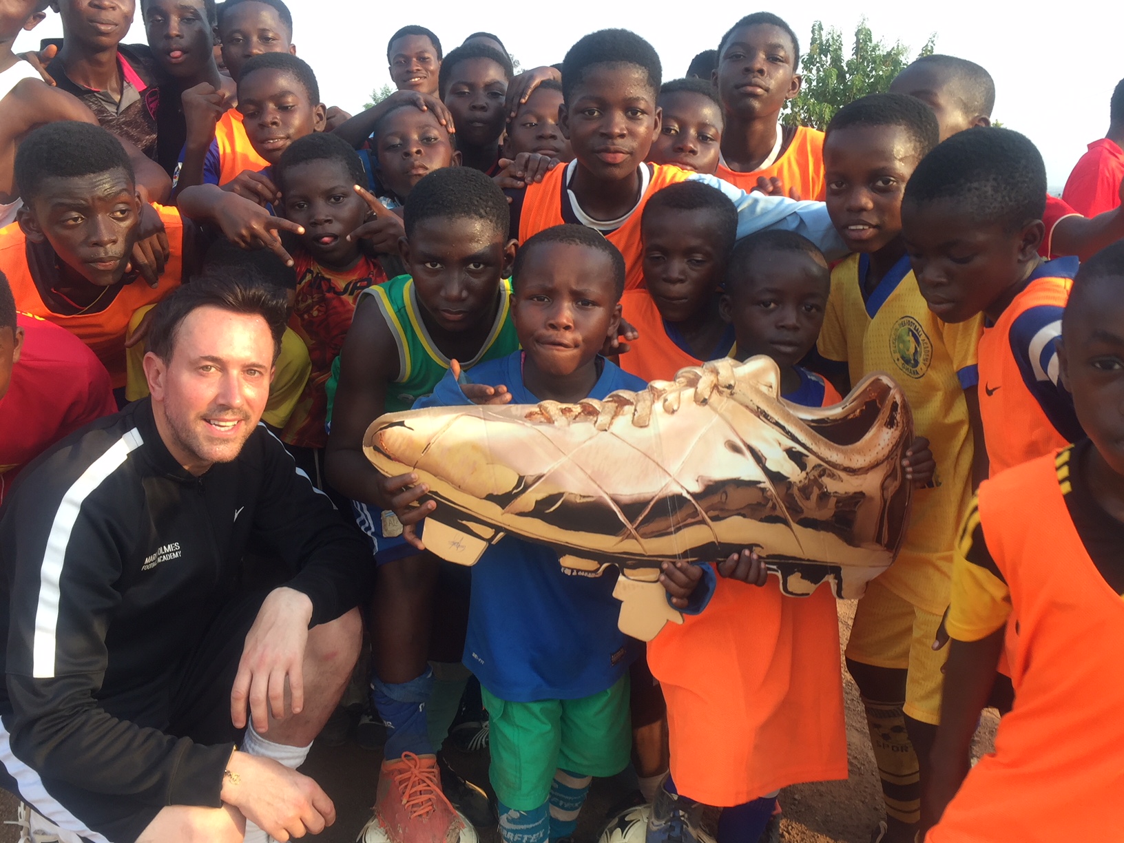 Coach Mark Holmes with pupils at his football academy in Ghana