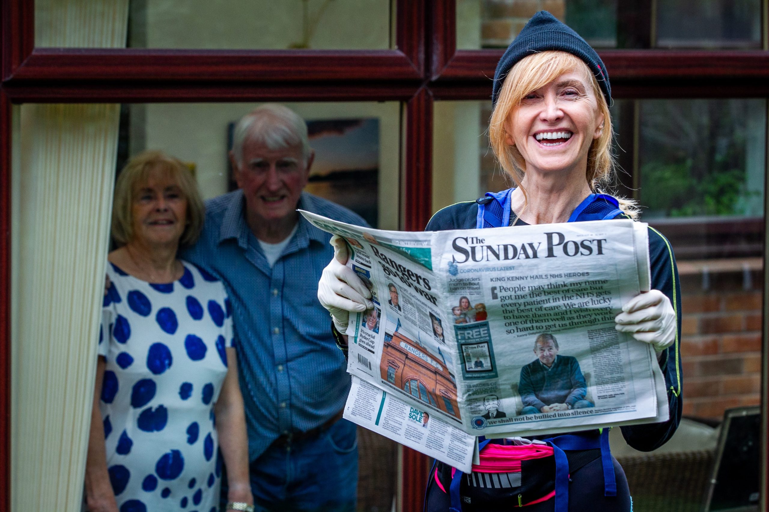 Out for her daily run that has turned into a paper round, broadcaster Jackie Bird drops off a Post with parents,                 Ronnie and Linda, in East Kilbride