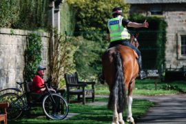 Police on horseback patrolling Pollok Park in Glasgow, asking people to move along if                         they are sitting down yesterday