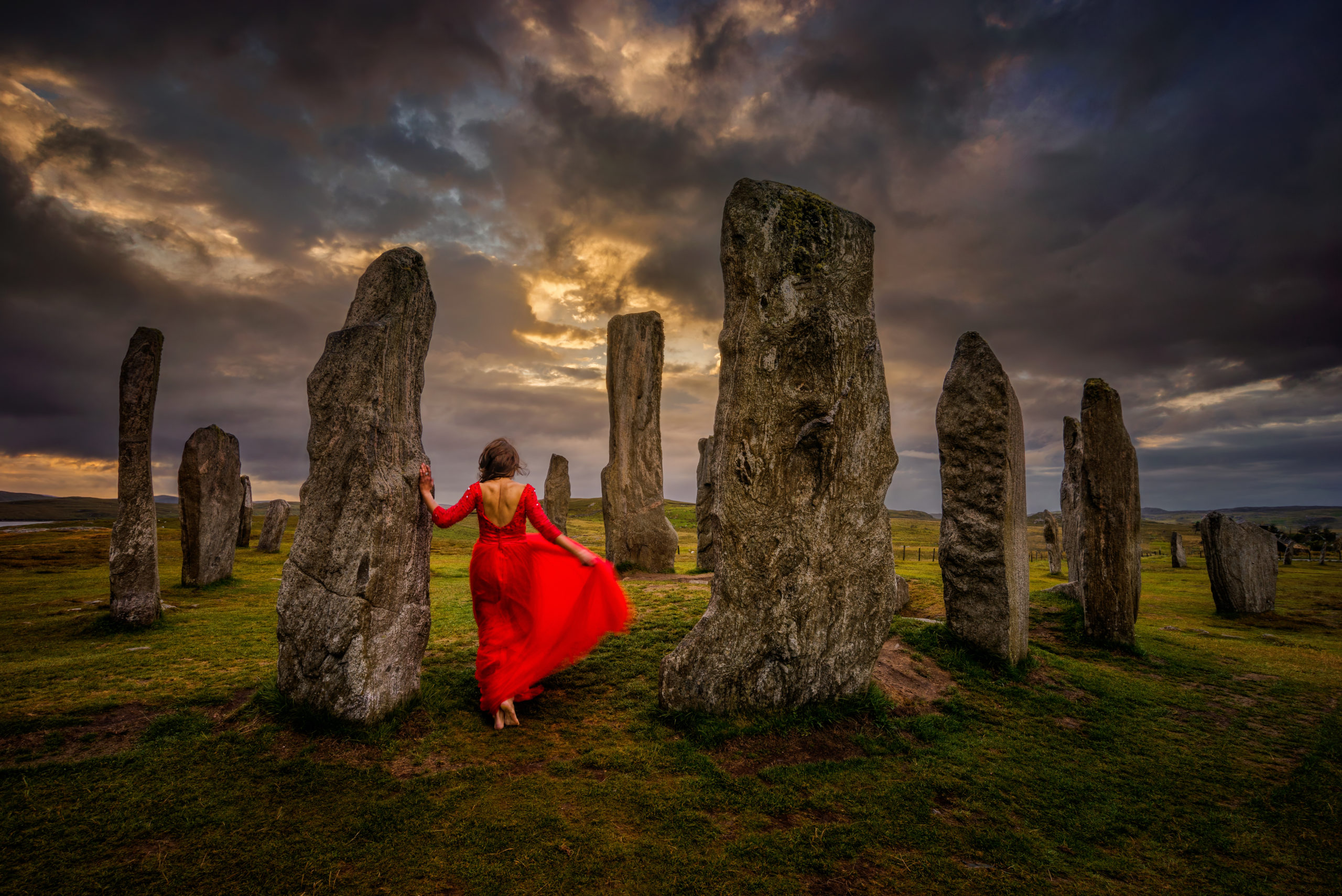A lady in red at the mysterious Callanish Stones on Lewis
