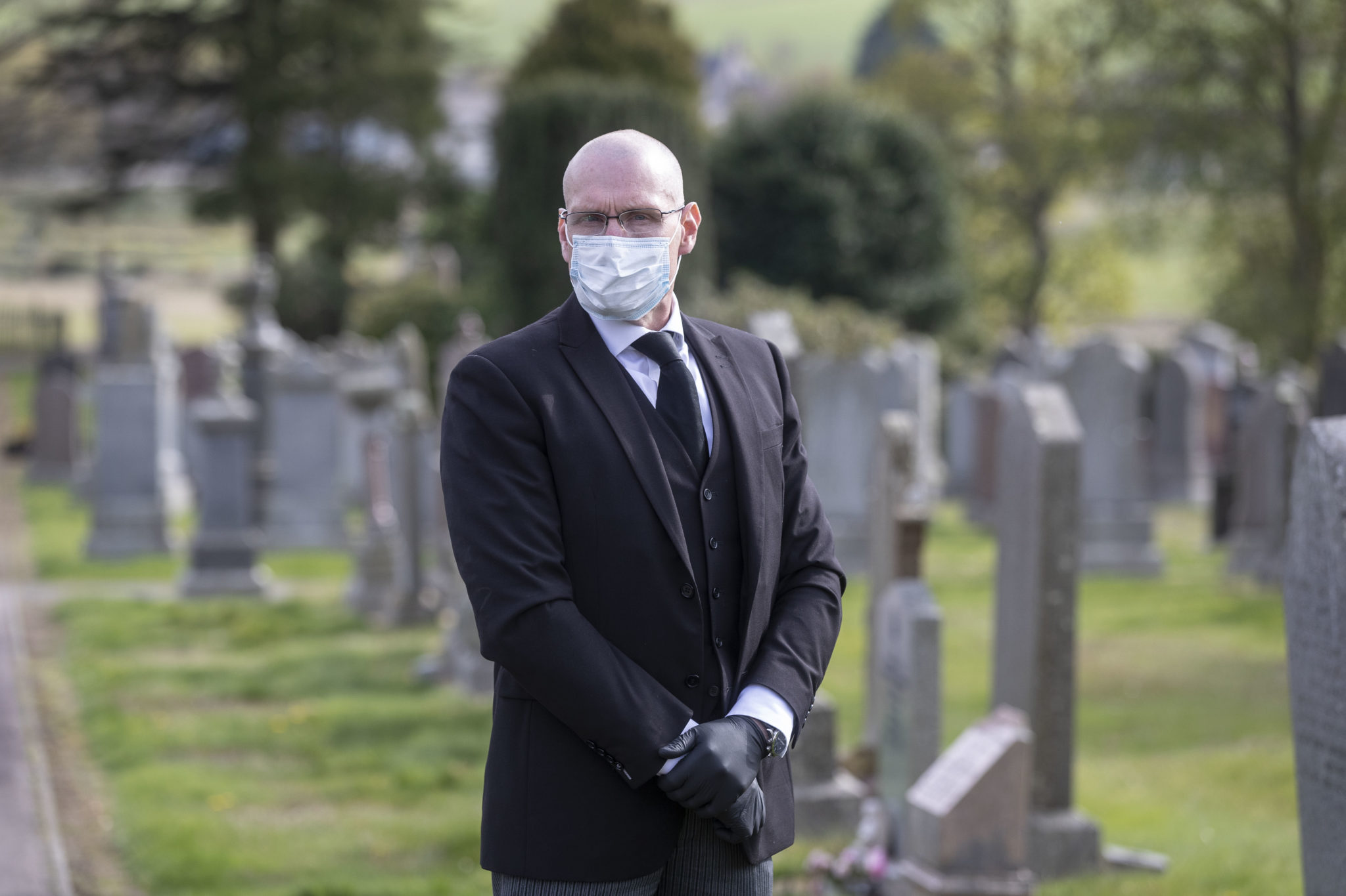 Funeral director: 'By the graveside, in our masks and gloves, we can