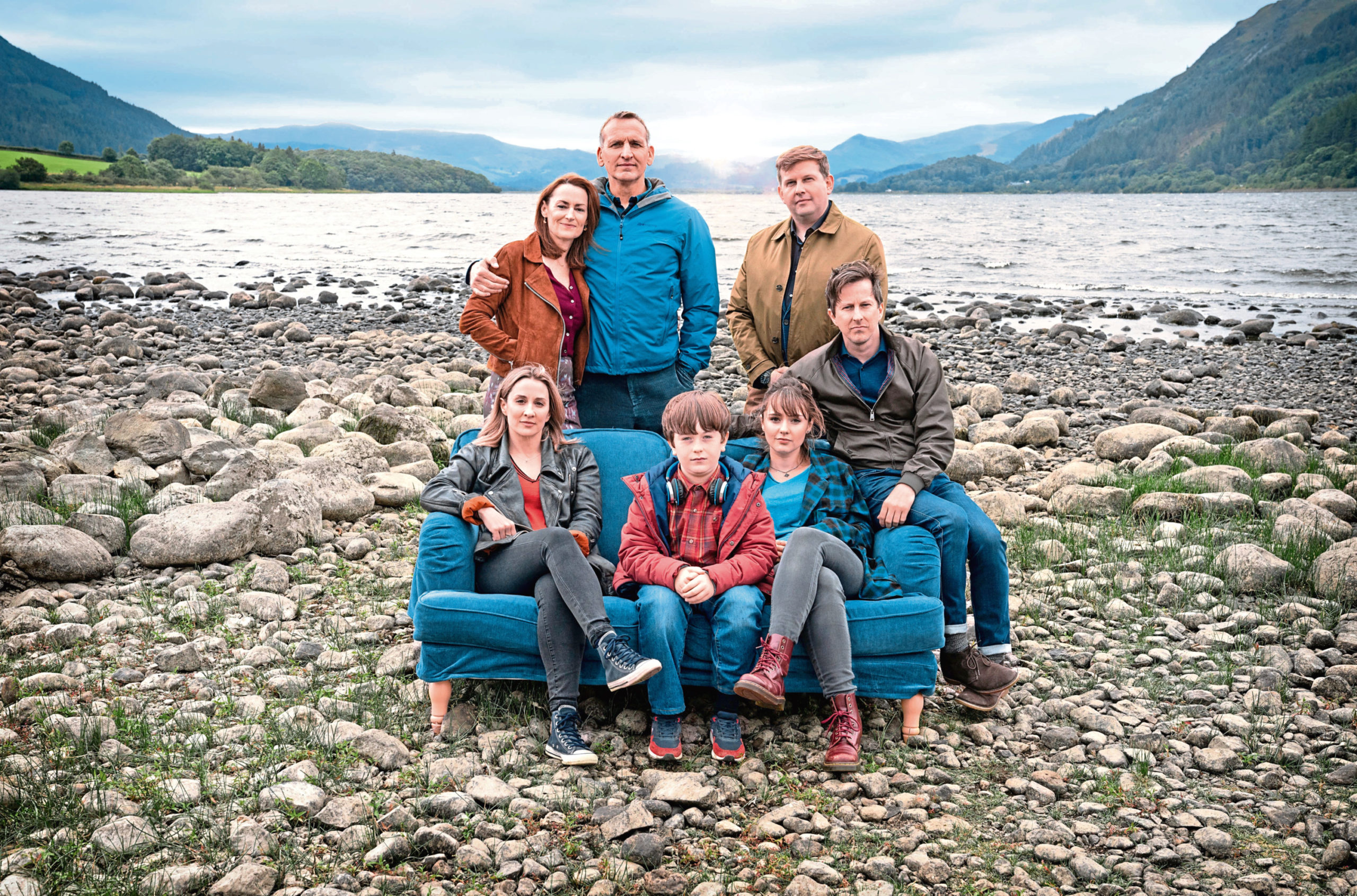 On the sofa from left: Morven Christie as Alison, Max Vento as Joe, Molly Wright as Rebecca, Lee Ingleby as Paul. Back row: Pooky Quesnel as Louise, Christopher Eccleston as Maurice and Greg McHugh as Eddie