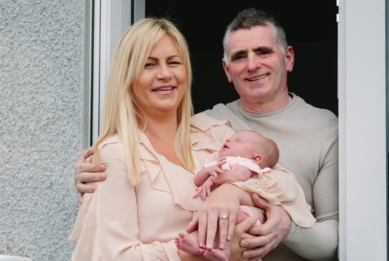 Laura McCormack, with her newborn baby, Ella-Rose, along with partner Robert