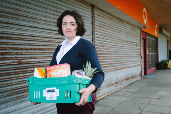 Laura Reilly at Crawfurds Burn Community Centre in Greenock with a food box for the vulnerable