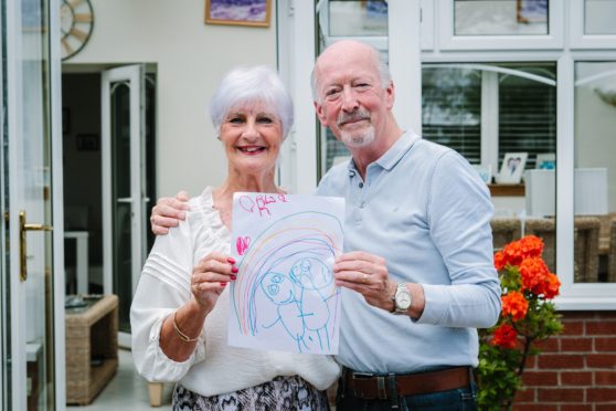 Lorna and Philip Begley with granddaughter Orla’s drawing of newborn twins