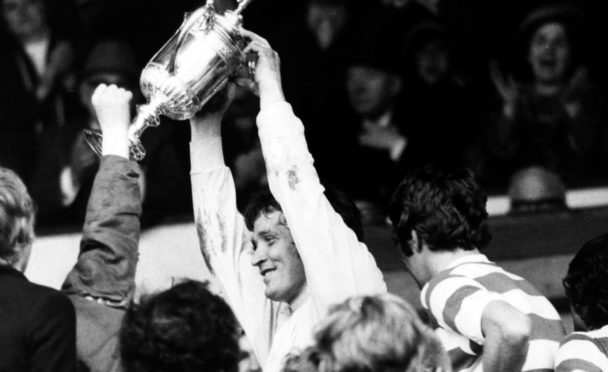 Evan Williams holds up the Cup, having played his part