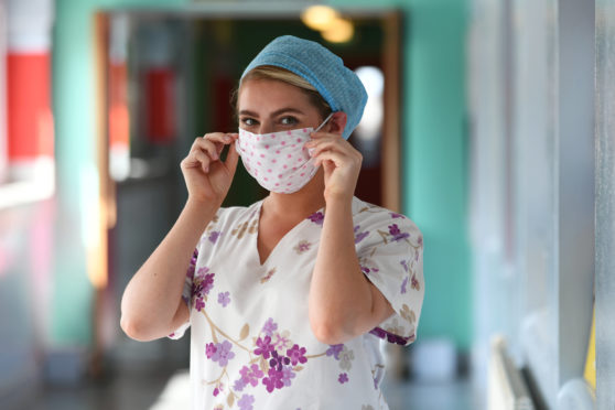 A Glasgow Royal Infirmary nurse in scrubs made from bedsheets