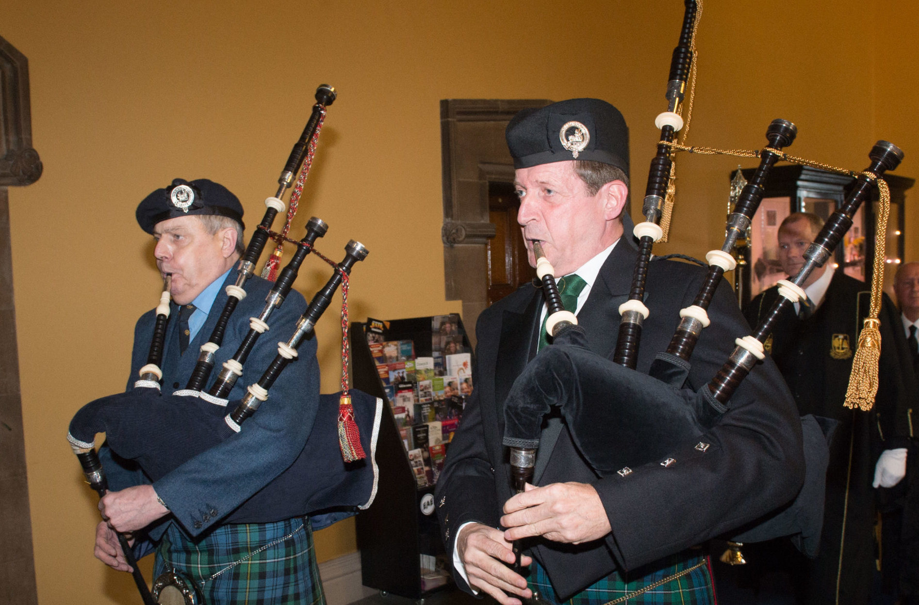 Alastair (right) piping at Glasgow University