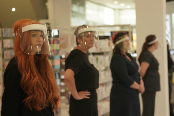 Staff in visors at a store in Newcastle