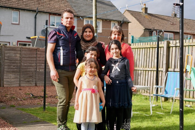 One of the first families the charity helped, Yahya and Ahed Hilal are pictured with their daughters Assma, Shaima and Fatima and volunteer Home Visitor Marisa Rosie