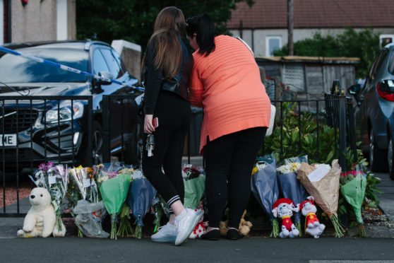 Flowers are laid outside the property