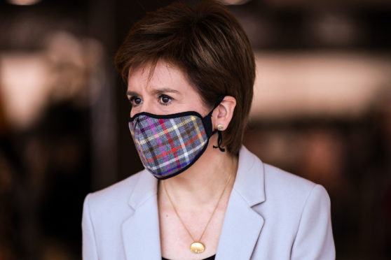 First Minister Nicola Sturgeon wearing a tartan face mask