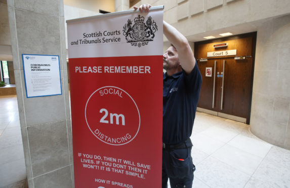 Social distance signage outside Courtroom Five at Glasgow Sheriff Court