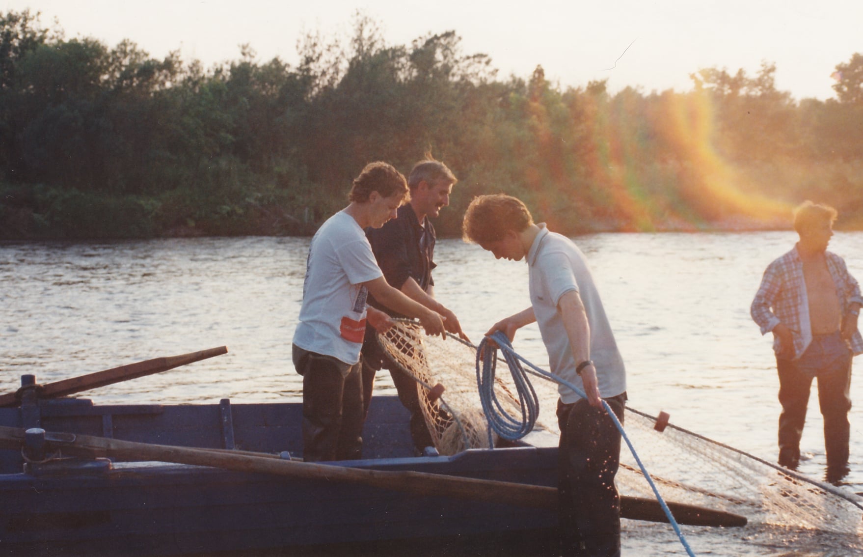A crew haul their nets in shallow inshore waters