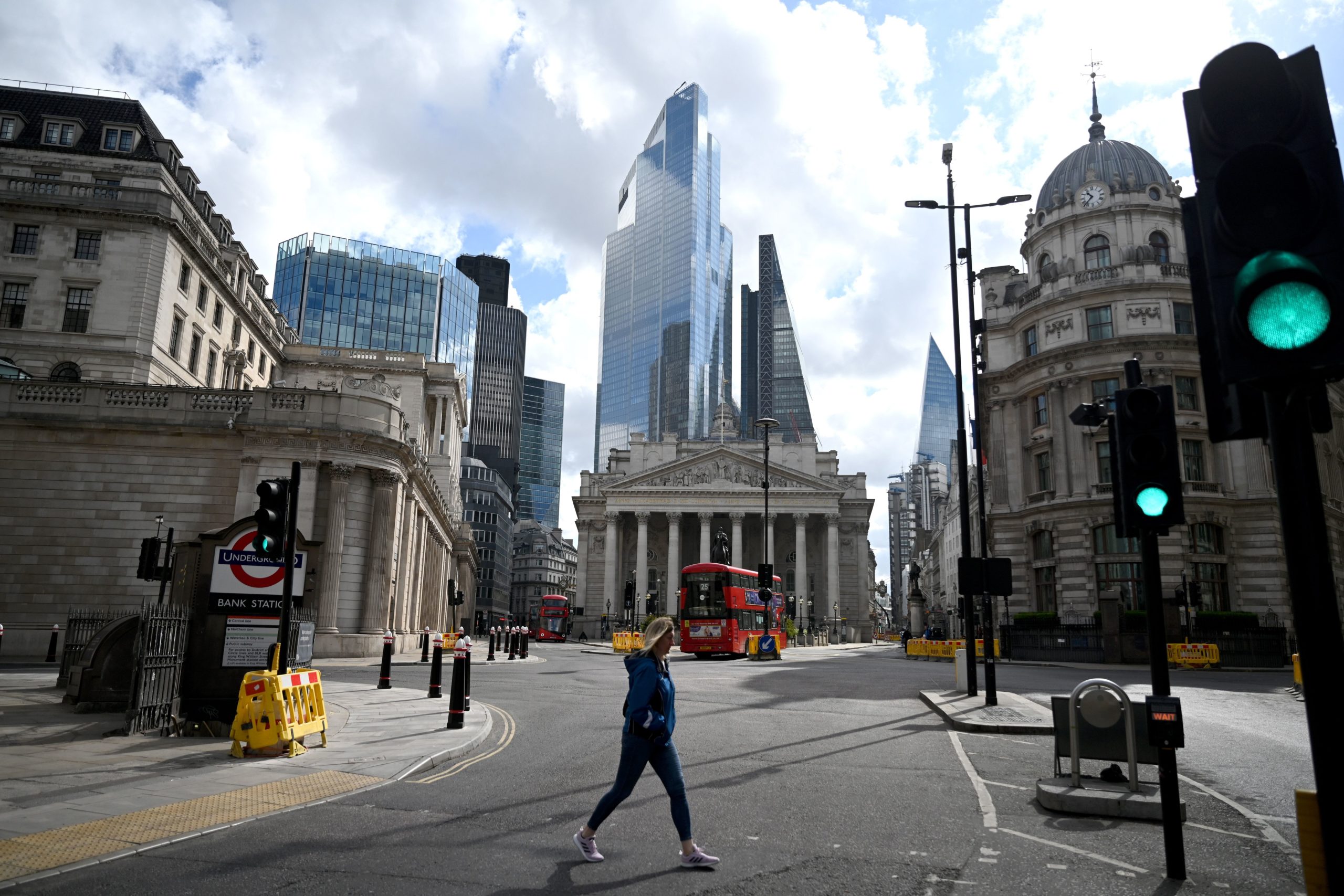 Woman walks in front of Bank of England in London during lockdown.