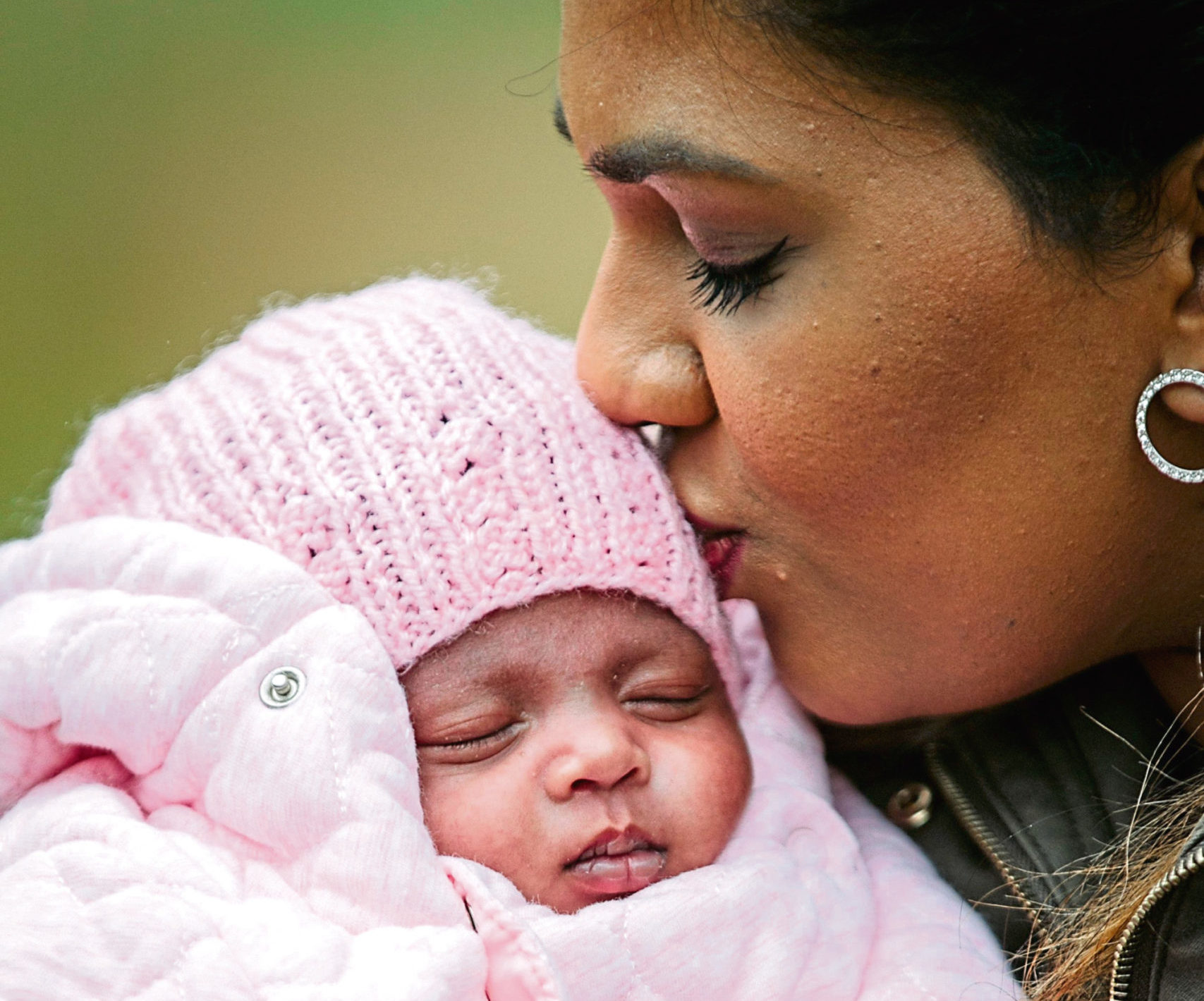 Ashvine, fully recovered, kisses her baby daughter Ashika Evie, who was born six weeks early