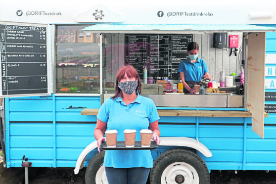 Lorraine Mann, front, and Ruby Harrower work in masks                       at the Drift Cafe in North Berwick