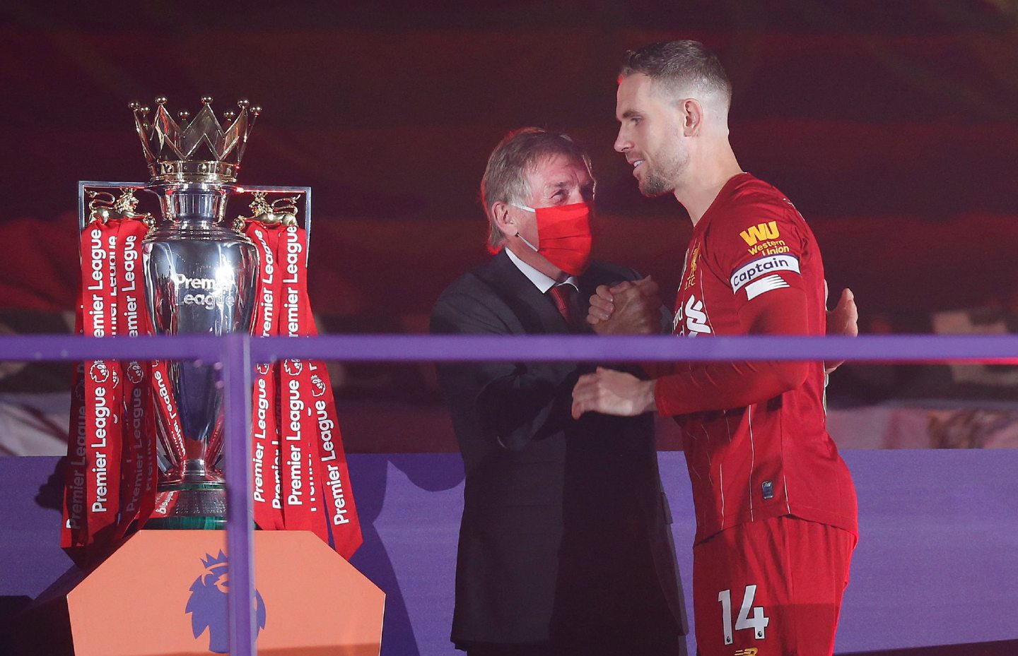 Sir Kenny congratulates Jordan Henderson as the Liverpool captain gets the Premier League trophy