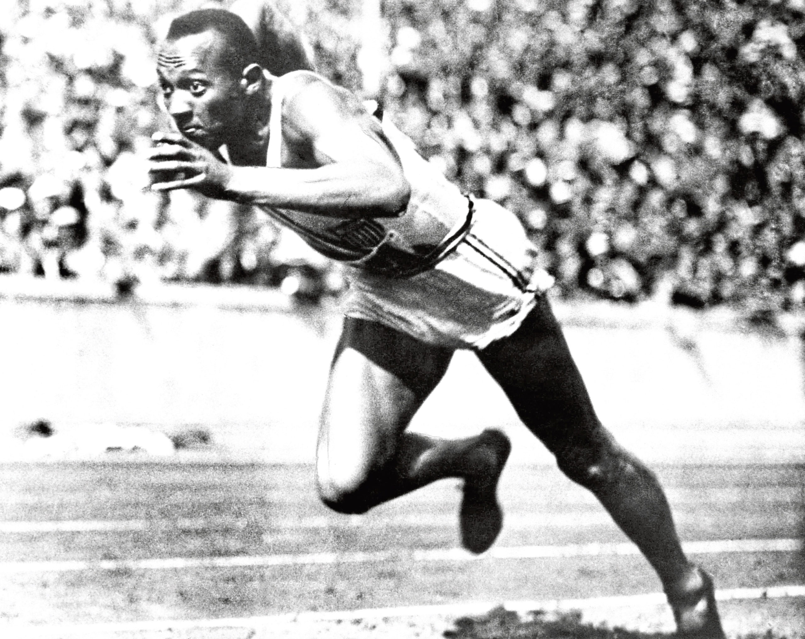 Jesse Owens competes in one of the heats of the 200-meter run at the 1936 Olympic Games in Berlin