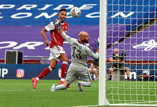Pierre-Emerick Aubameyang cooly clips the ball over Chelsea keeper Willy Caballero for his second goal of the match