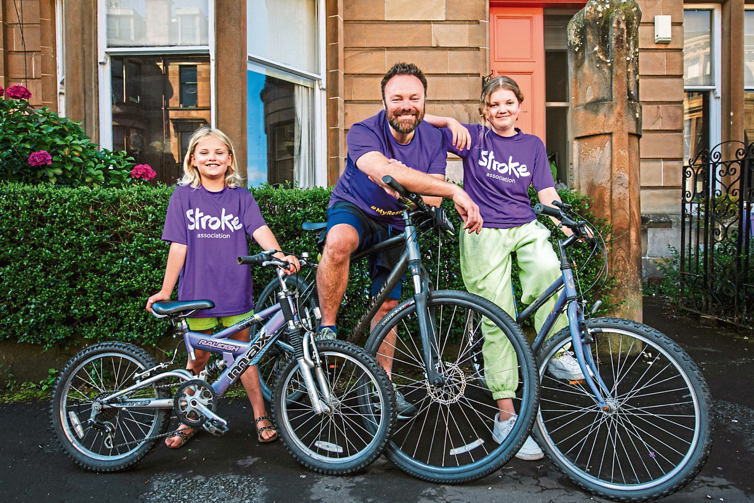 Stephen and daughters Elsa and Thea who are cycling to raise funds for the Stroke Association