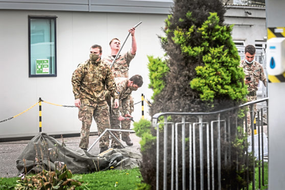 Soldiers erect a tent at the 2 Sisters food plant in Coupar, Angus to conduct Covid testing