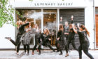 Team members celebrate the success of Luminary Bakery, which helps disadvantaged women and won the Duchess of Sussex’s support