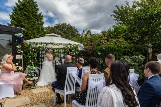 Rebekah and Matt take their vows in front of guests in her gran and grandad’s back garden