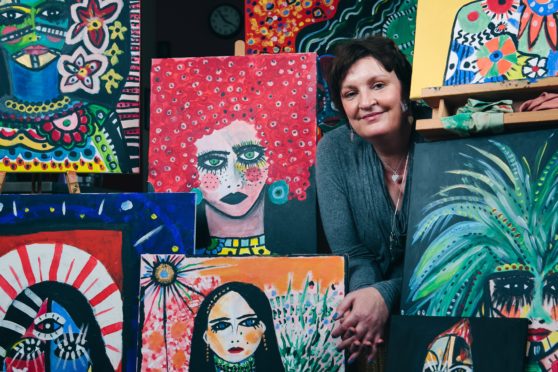 Daniela Nardini with some of her paintings