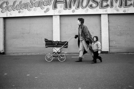 Graham took this picture of an unknown family in Portobello in 1987. The baby in the pram, Kirstyn Cameron, discovered the photo of herself, mum Mary Jane and big brother Matthew on a Facebook group