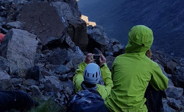 A search and rescue helicopter arrives at the scene on Skye’s Cullins as climbers look on