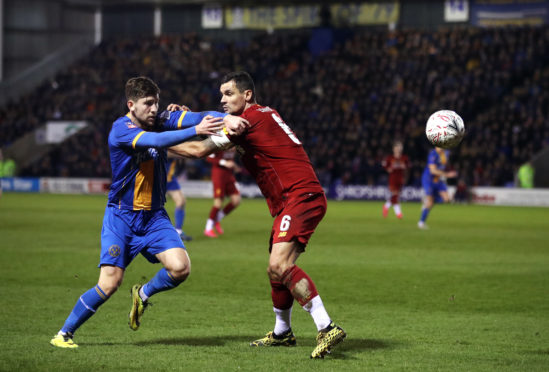 Callum Lang tussles with Dejan Lovren during Shrewsbury Town’s FA Cup fourth-round tie with Liverpool in January
