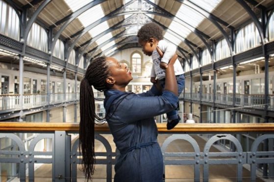 Mercy Baguma with her baby son at Glasgow's The Briggait in July last year