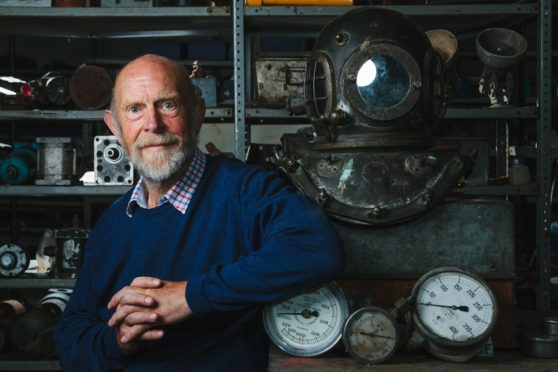 Salvage expert Alec Crawford at home in Newport-on-Tay, Fife, with artefacts from his dives