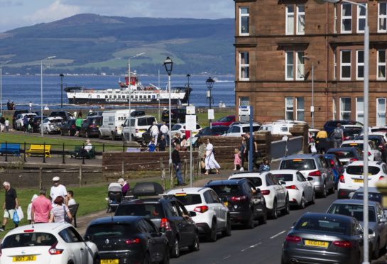 Day trippers queue in Largs for the Isle of Cumbrae, Millport ferry as temperatures rise on the weekend before the kids finally go back to school.