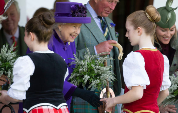 The Queen receives a posy at the Braemar Highland Gathering in September last year