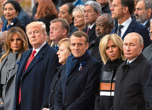 First lady Melania Trump, U.S. President Donald Trump, German Chancellor Angela Merkel, French President Emmanuel Macron and Brigitte Trogneux and Russian President Vladimir Putin.