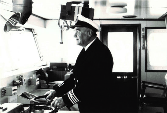 Captain Robin Hutchison at the helm