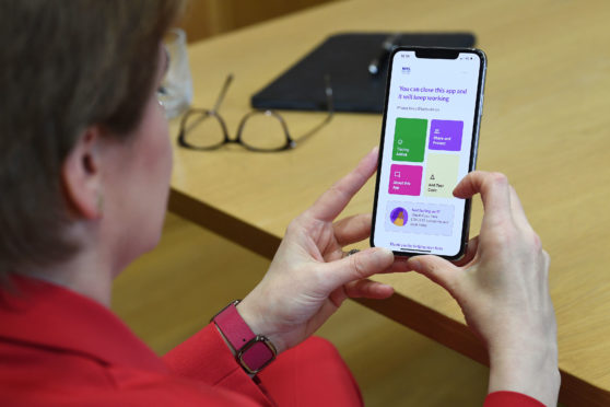 First Minister Nicola Sturgeon views the new Covid-19 track and trace app.